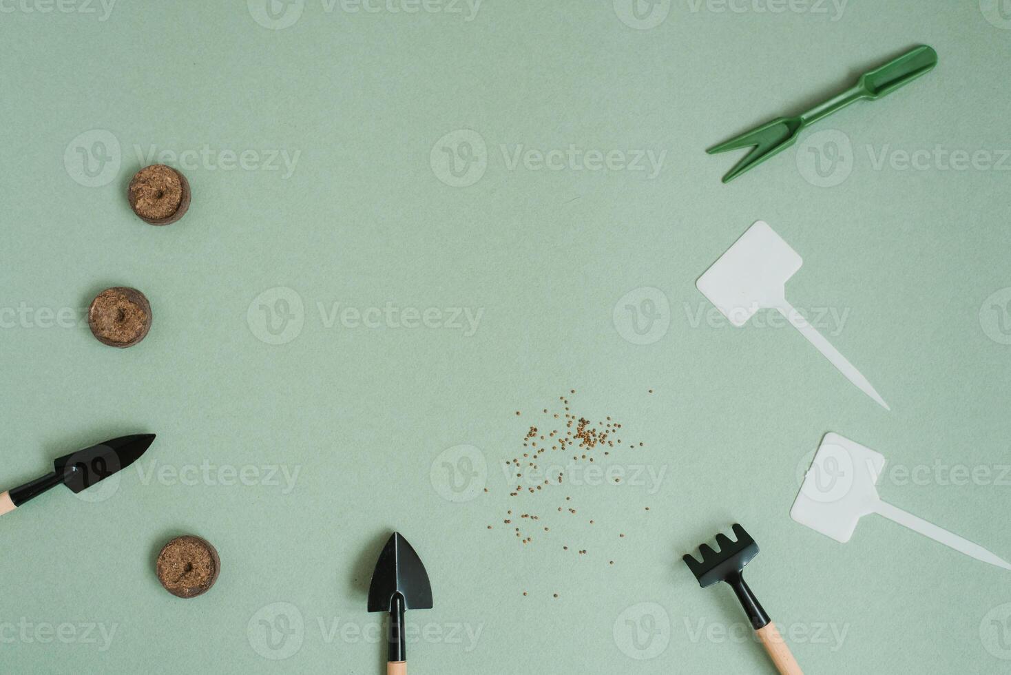 Accessories for garden tools, miniature flat surface on a green background, gardening concept, top view, indoor garden photo