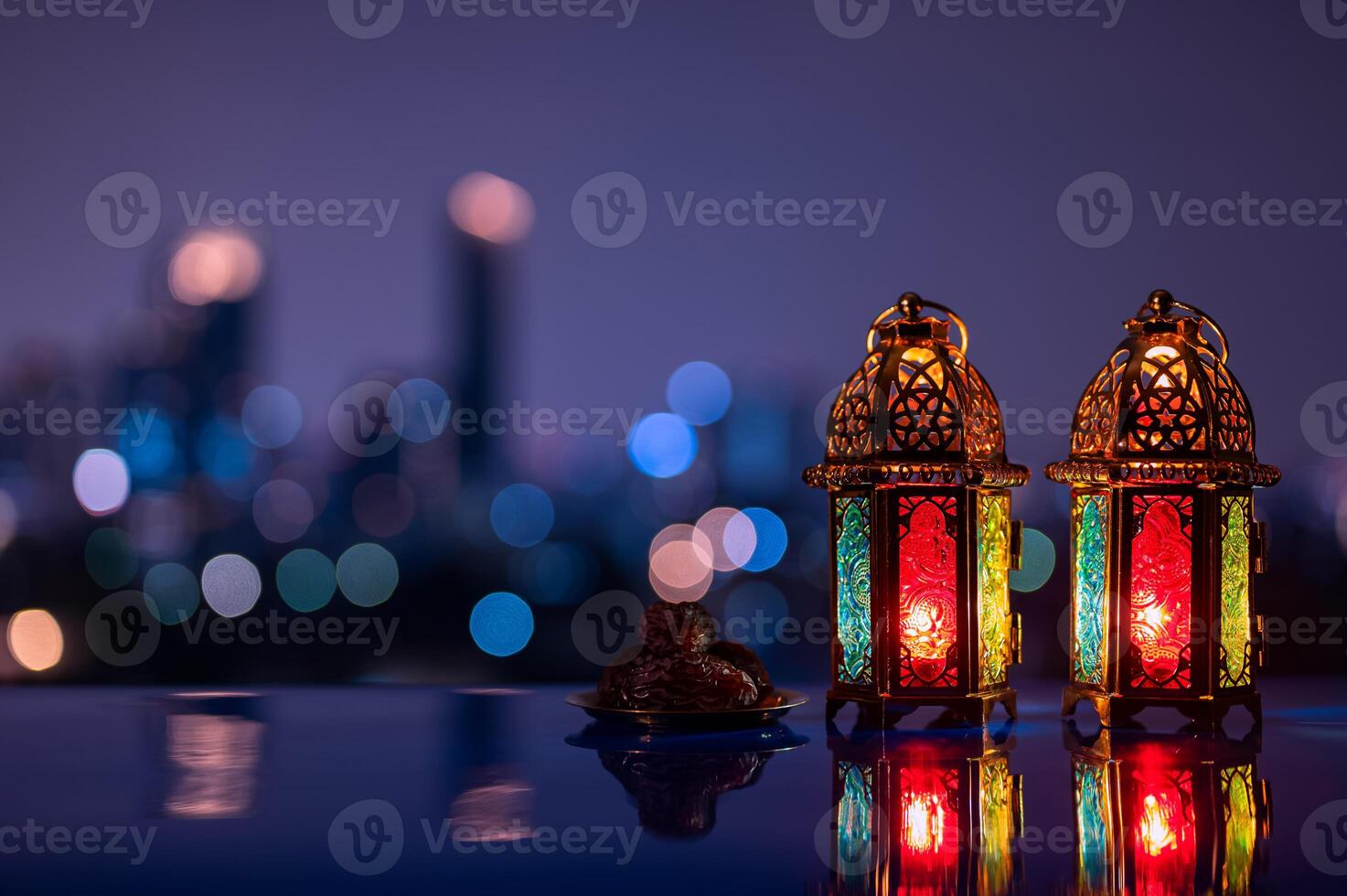 Two lanterns and small plate of dates fruit with night sky and city bokeh light background for the Muslim feast of the holy month of Ramadan Kareem. photo