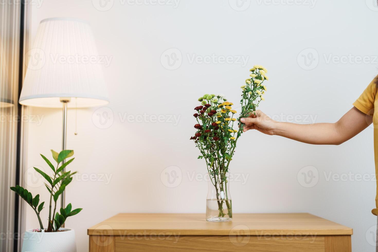 Woman hand arrange Colorful flowers bouquet in mason jar on table background. Happy day with fresh flower photo