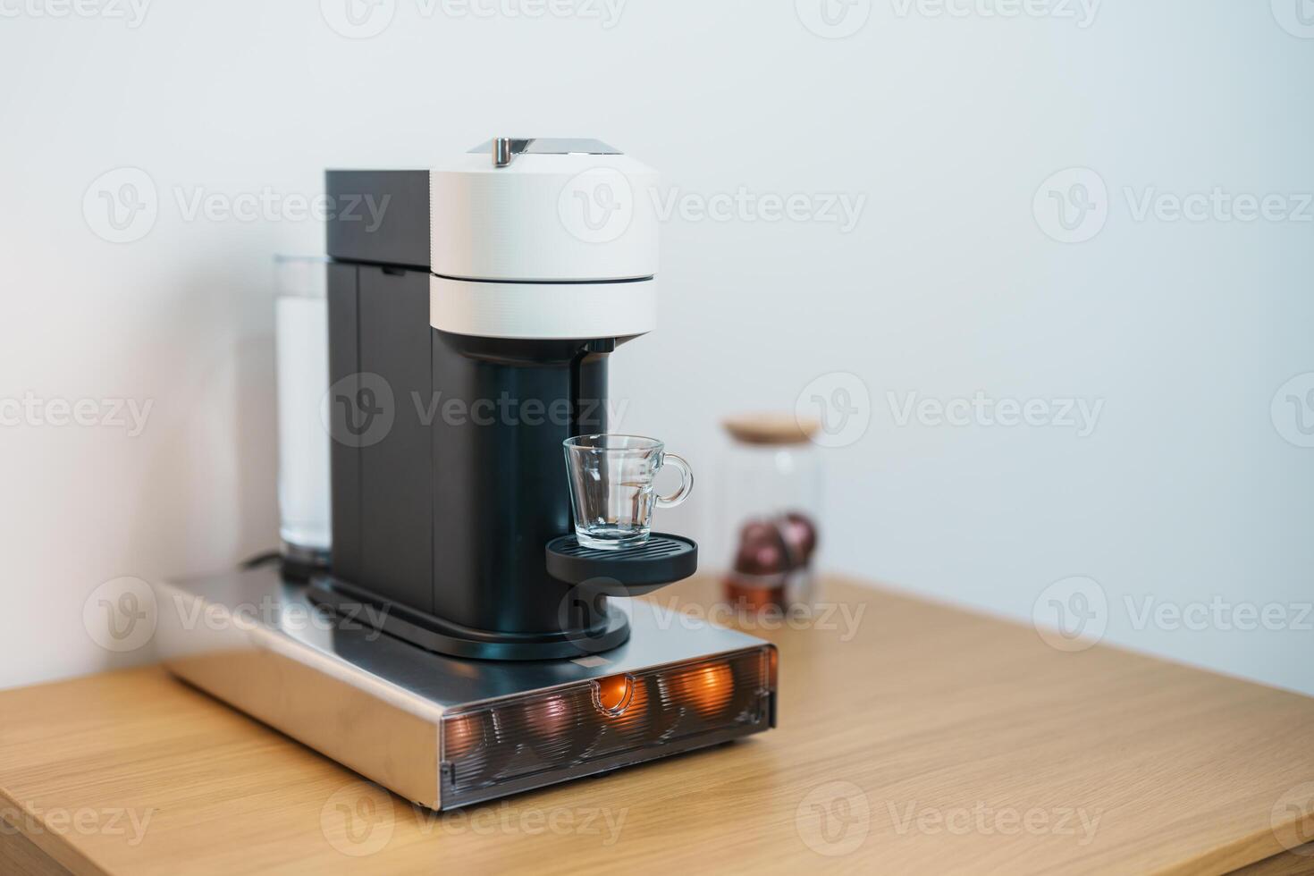 Espresso Coffee Maker Machine with Capsule of roasted coffee bean on wood table bar. Daily beverage drink at Home, Apartment and Office concept photo