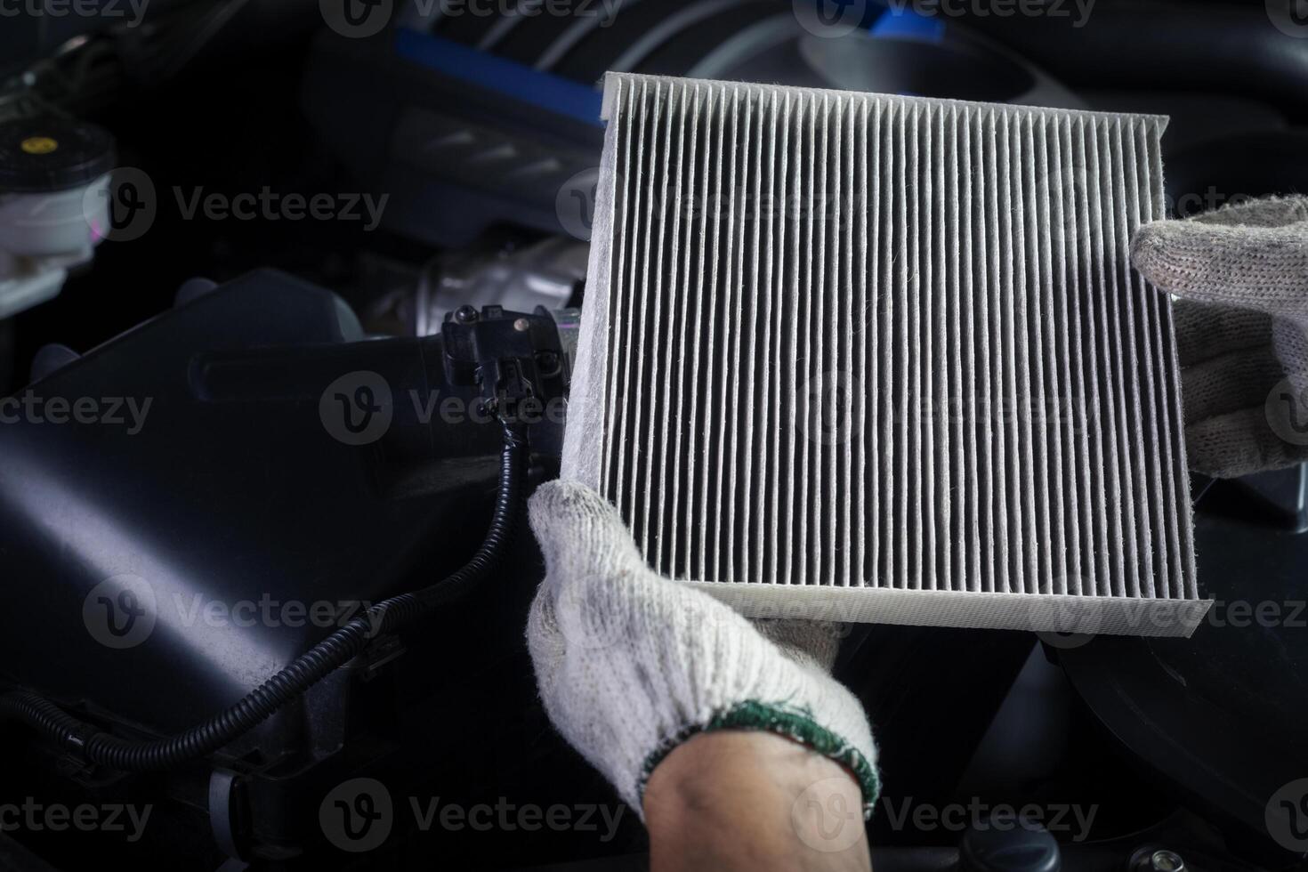 Car air conditioner system maintenance, Hand mechanic holding car air filter to check for clean dirty or fix repair heat have a problem or replace new or change filter. photo