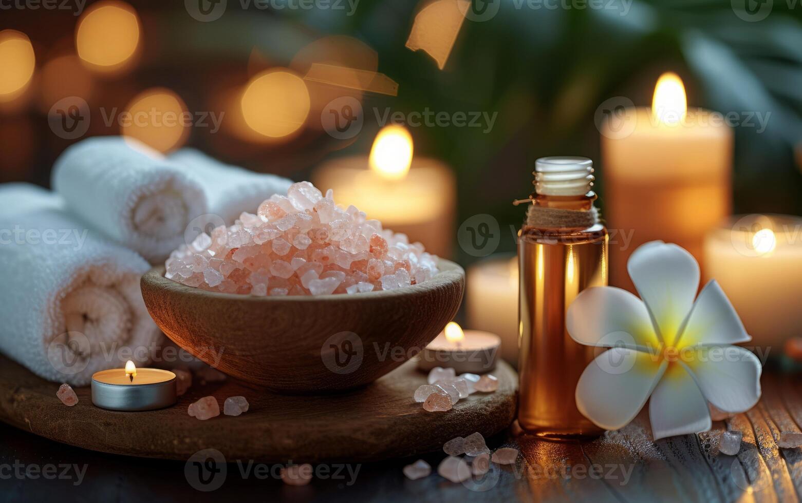 A calming spa scene with Himalayan salt, aromatic essential oils, frangipani petals, and soft candlelight photo