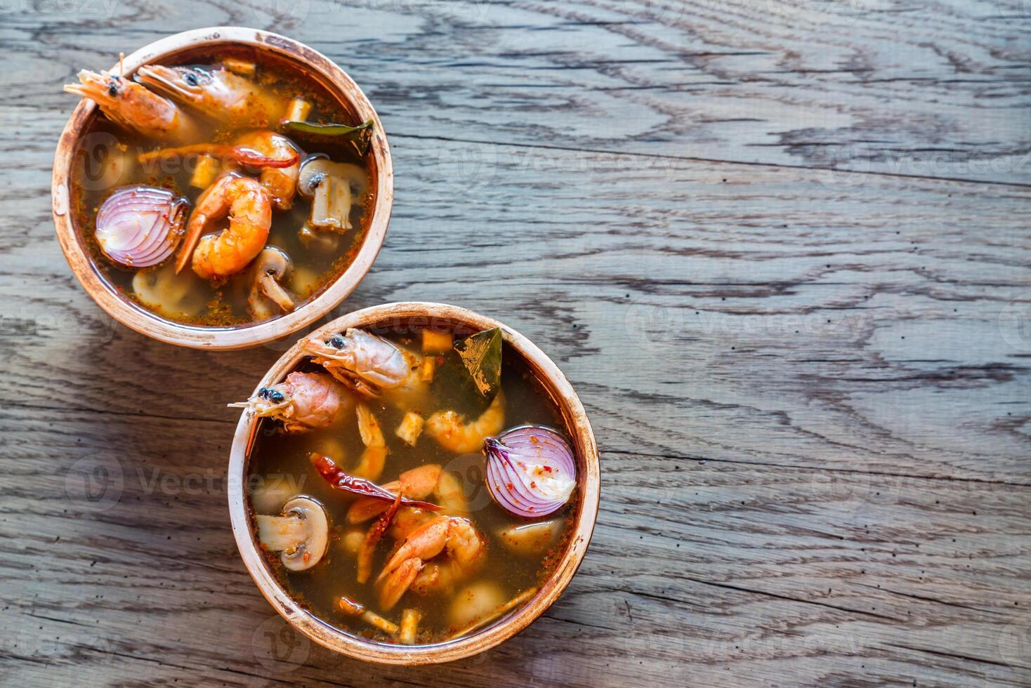Two bowls of thai tom yum soup photo