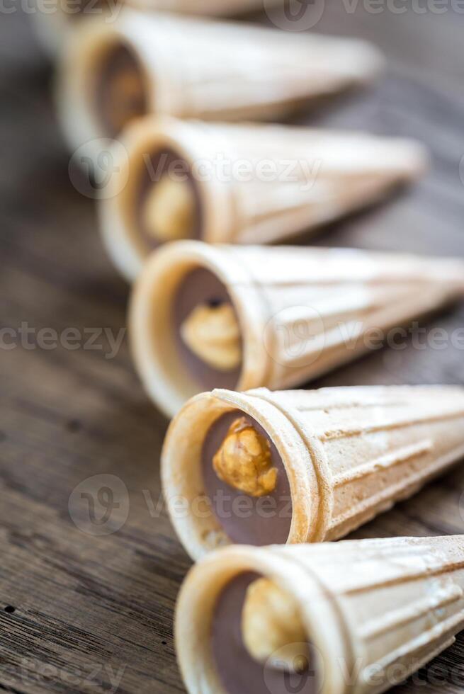 Crispy waffle cups with chocolate and hazelnuts photo