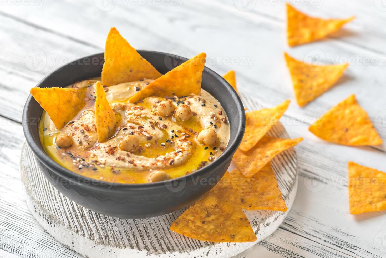 Bowl of hummus with tortilla chips photo