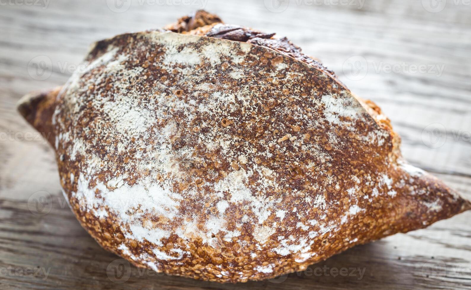 Wholegrain bread on the wooden background photo