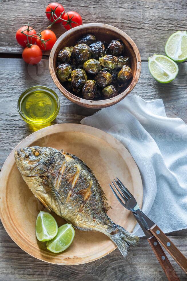 Grilled Dorade Royale Fish with fresh and baked vegetables photo