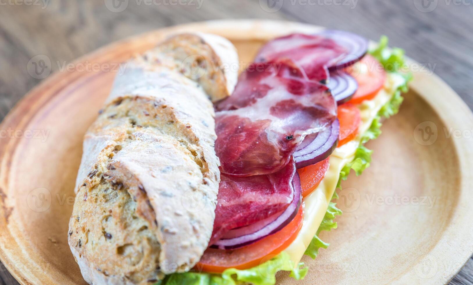 Sandwich with ham, cheese and fresh vegetables photo