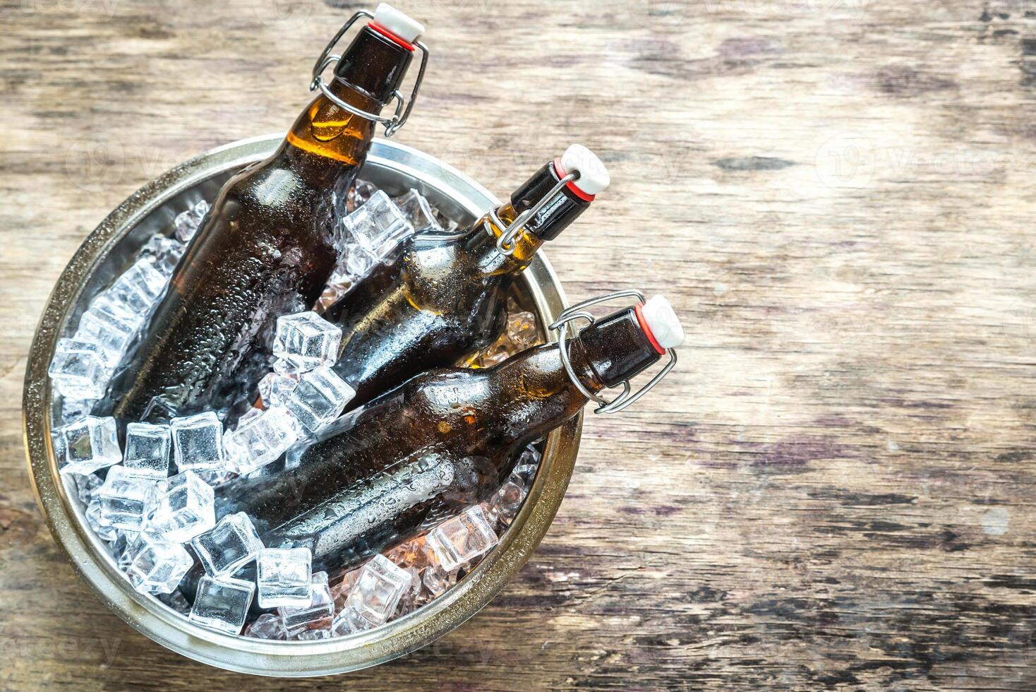 Bottles of beer in ice cubes photo