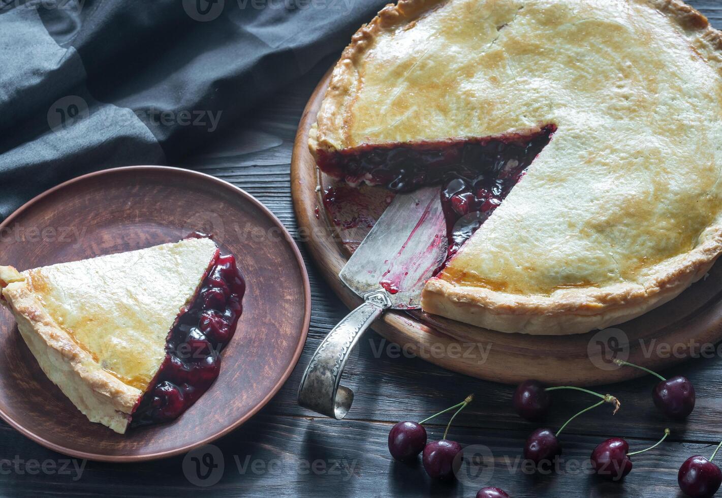 Cherry pie on the wooden background photo