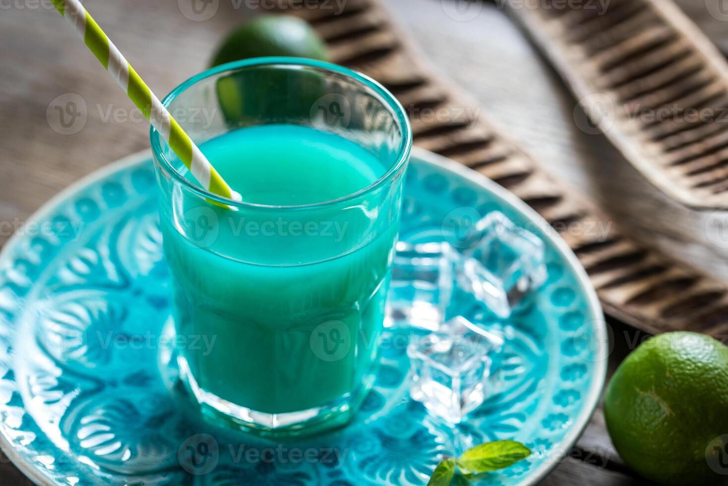 Glass of blue curacao and juice cocktail photo