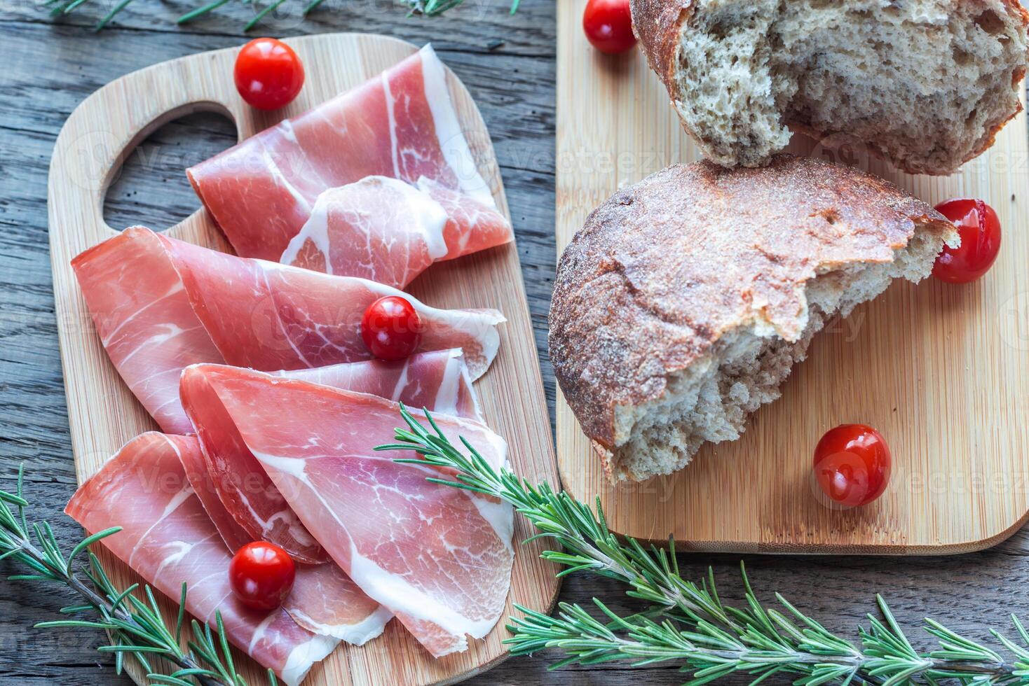 Slices of jamon on the wooden board photo