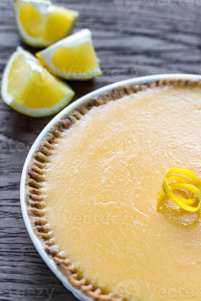 Lemon tart on the wooden background photo