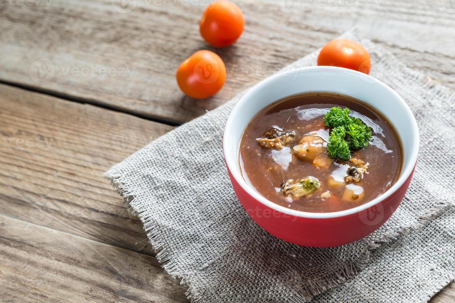 Spicy tomato soup with seafood photo