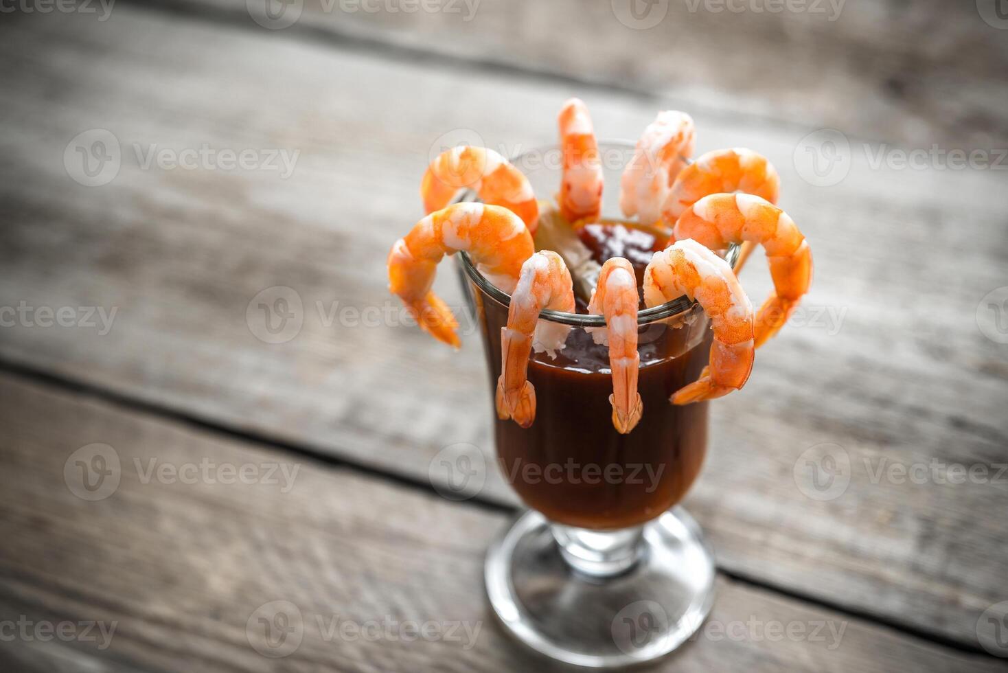 Cooked prawns  with tomato sauce on the wooden table photo