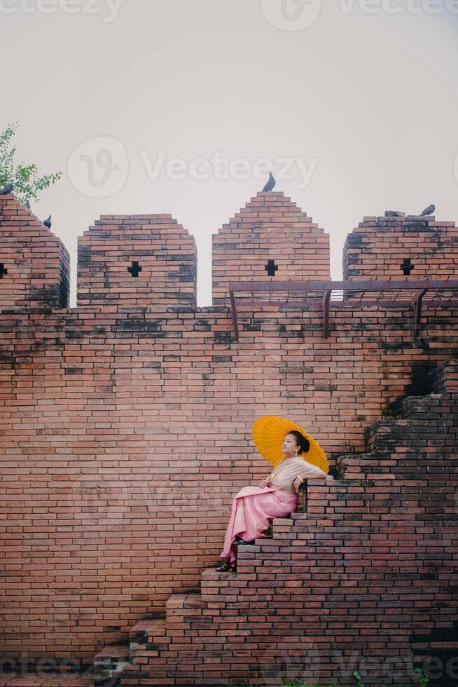 Girl in front of historical Tha Phae gate at Old city in Chiang Mai Thailand photo