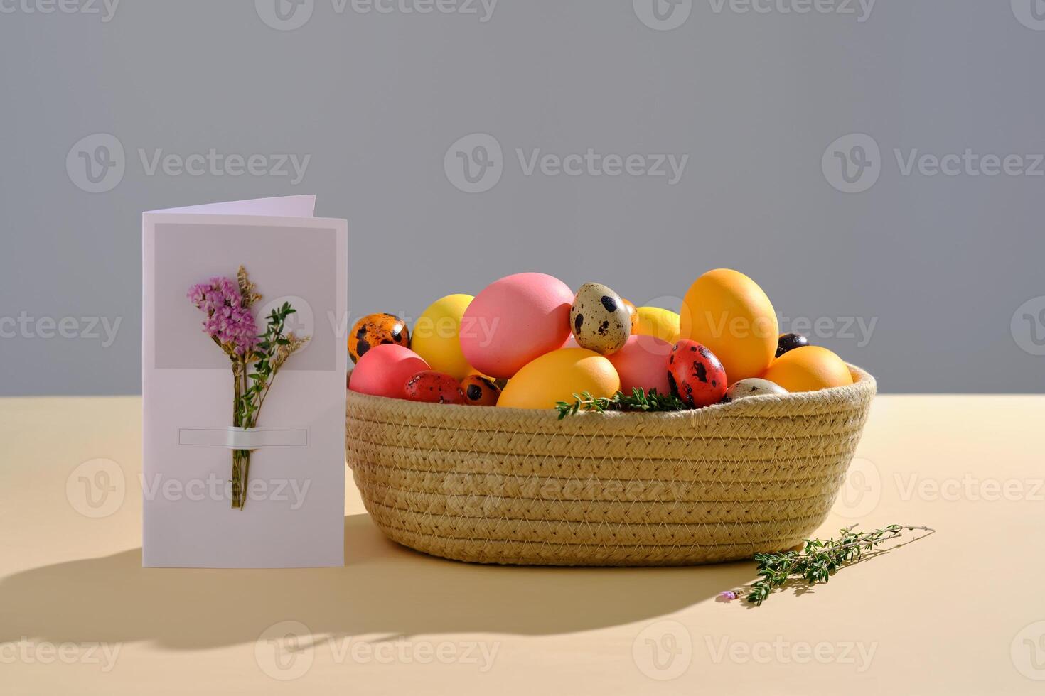 Easter colored eggs in a wicker basket. Easter composition. photo