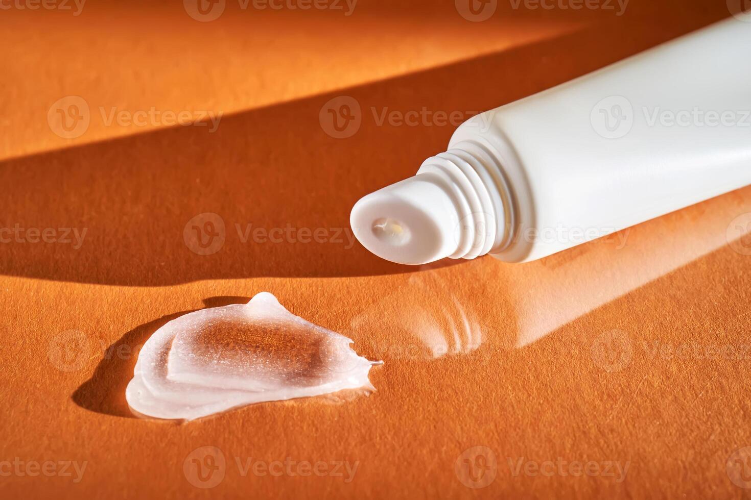 Hygienic moisturizing lip balm in a tube on a orange background. photo