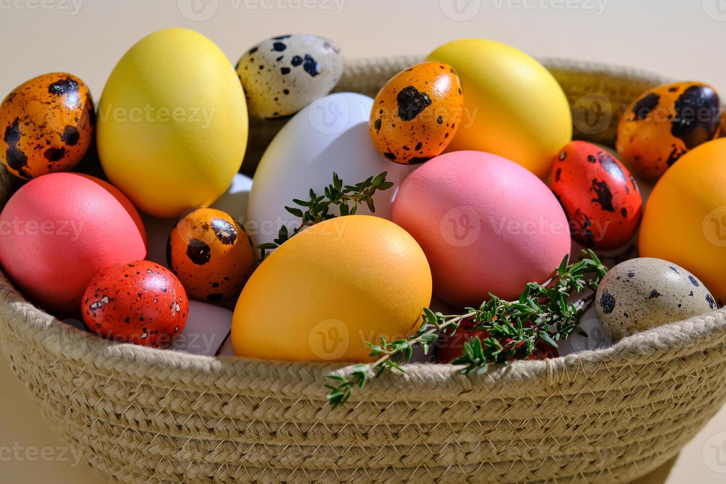 Easter colored eggs in a wicker basket. Easter composition. photo