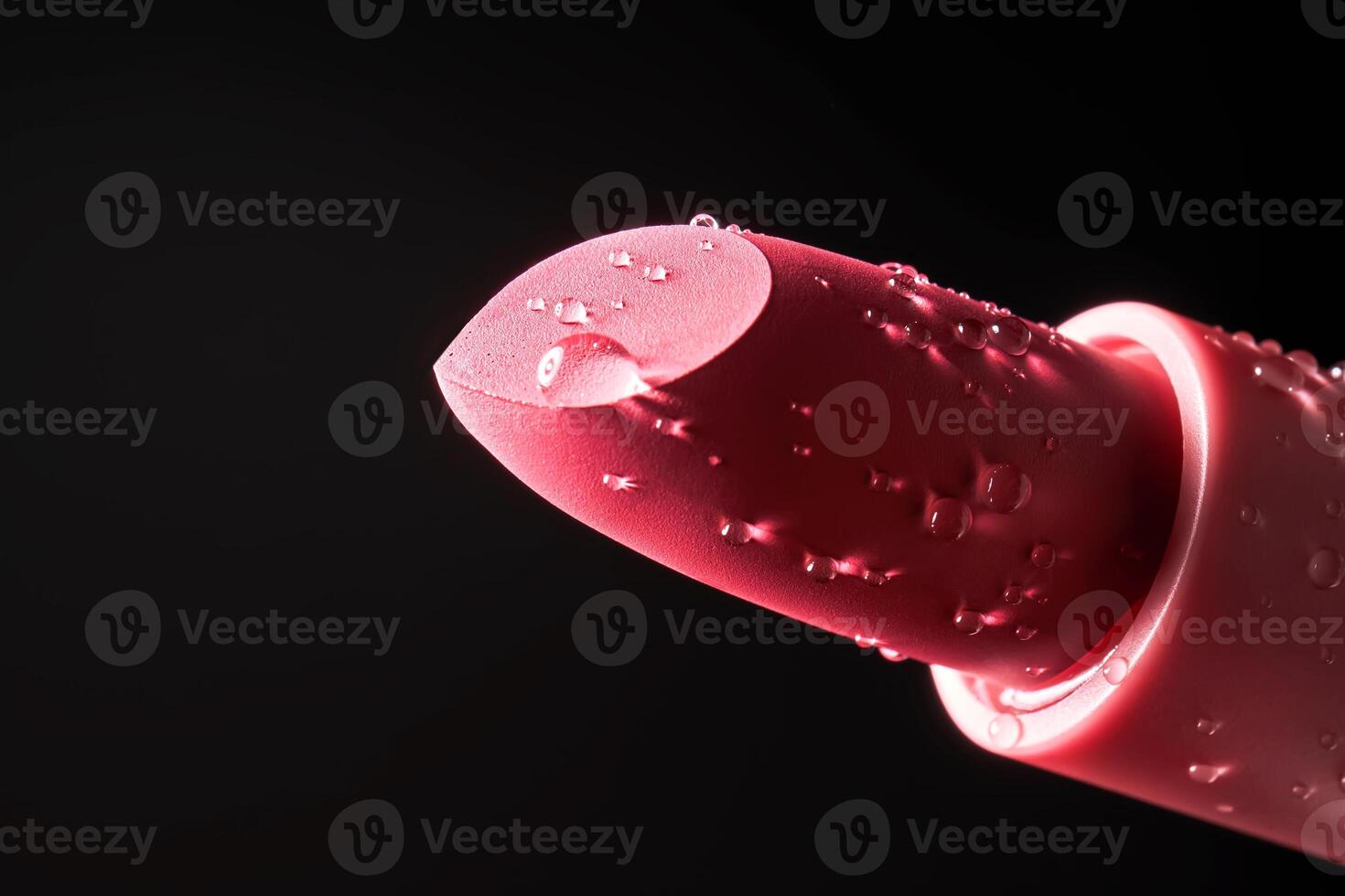 Red lipstick with water drops on a dark background. photo