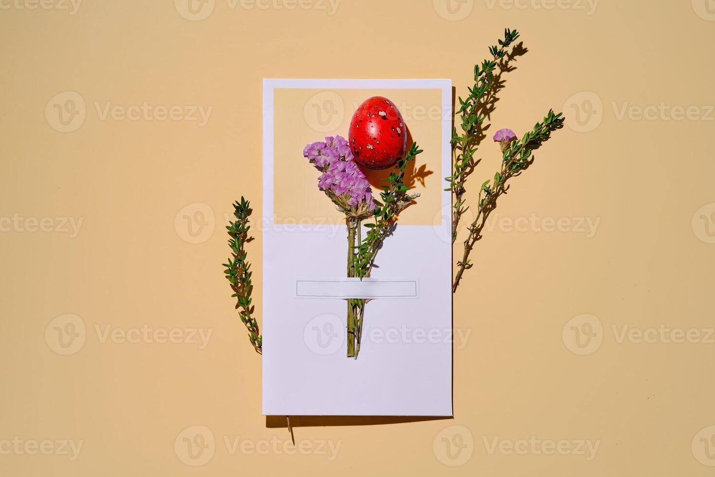 Easter card with a red quail egg on a beige background. photo