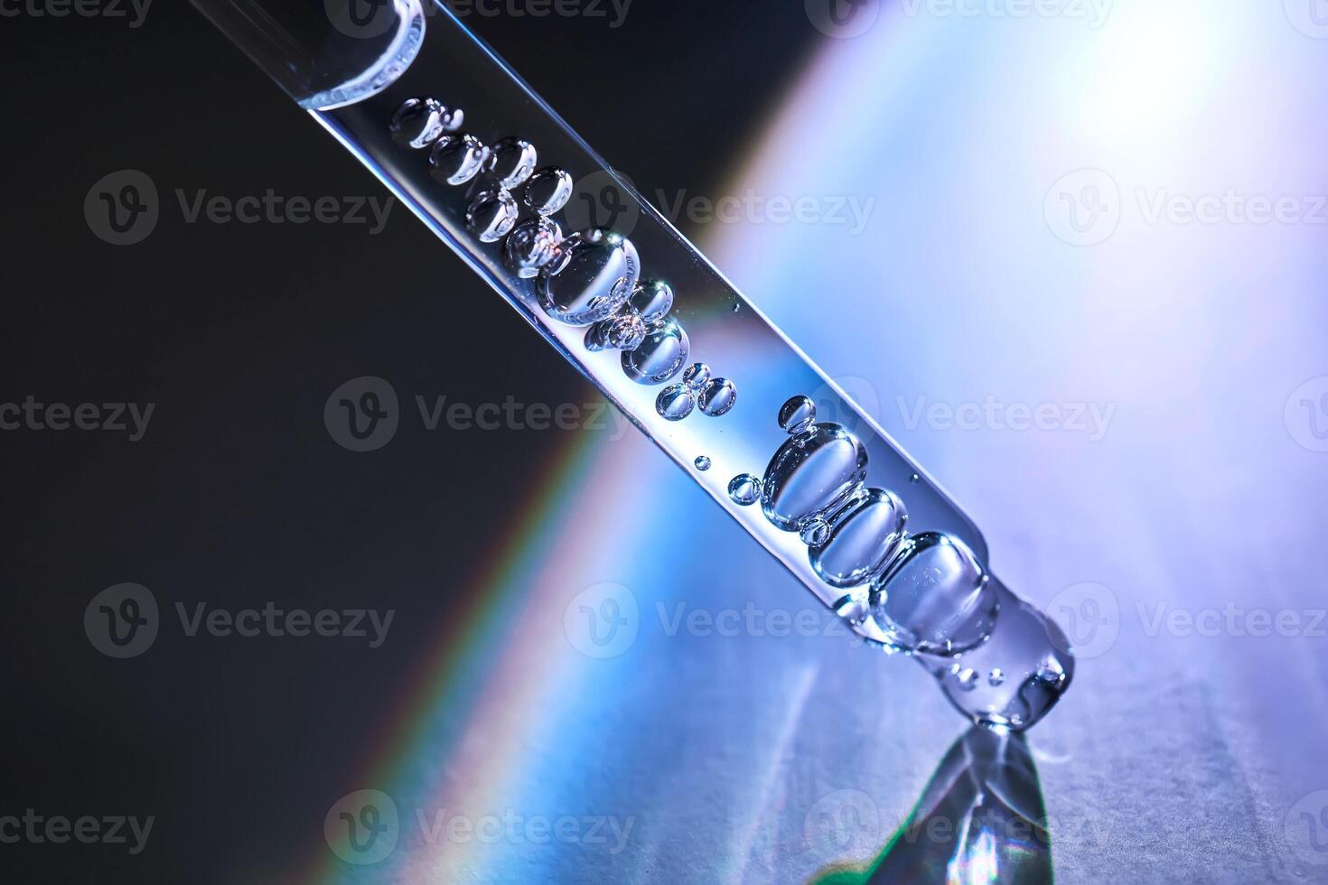 Pipette with serum in a space atmosphere. photo