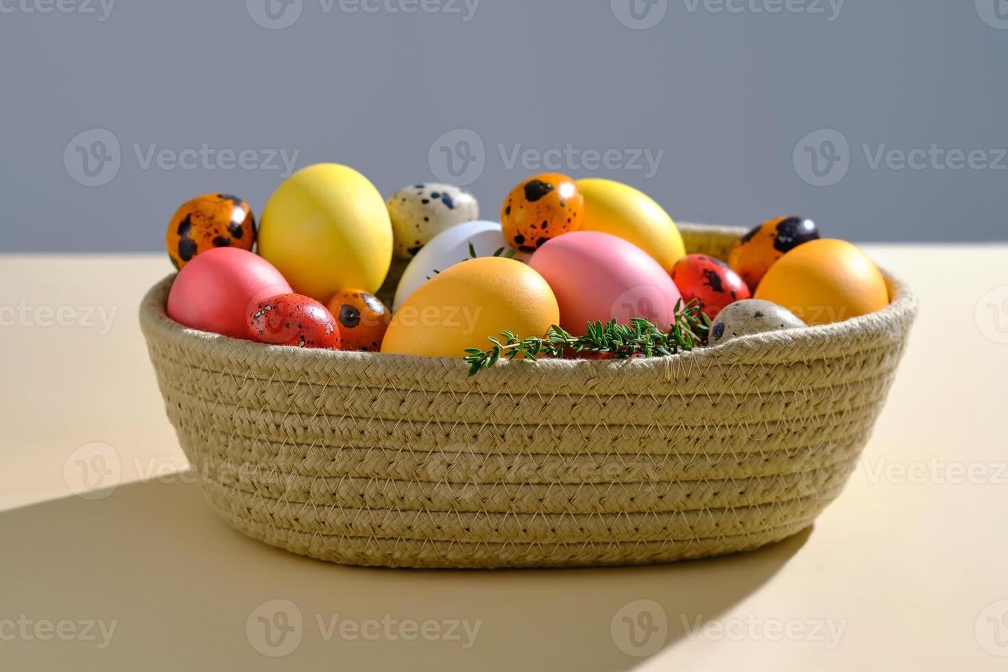 Easter colored eggs in a wicker basket. Easter composition. photo