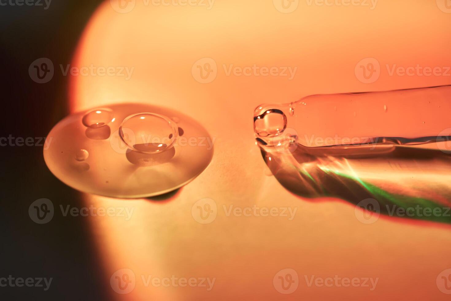 A drop of serum for the face on the border of light and shadow. photo
