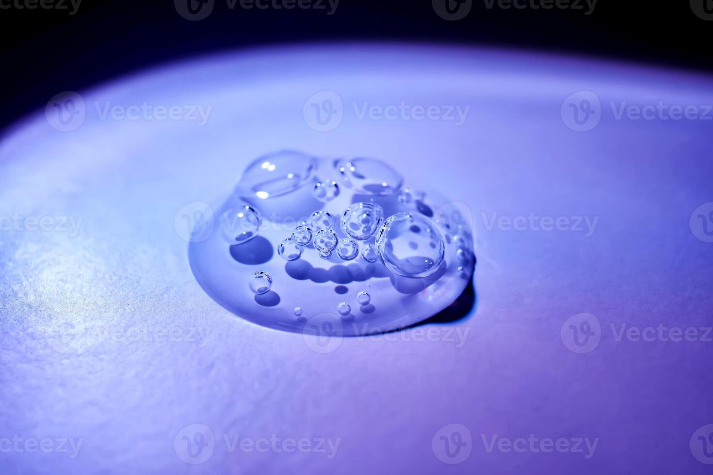 A drop of serum under ultraviolet light. photo