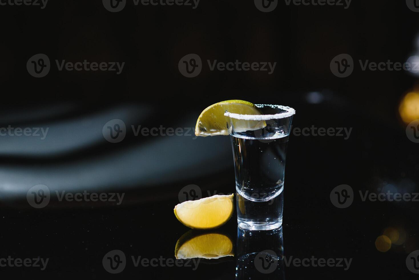 tequila with lime on a dark background photo