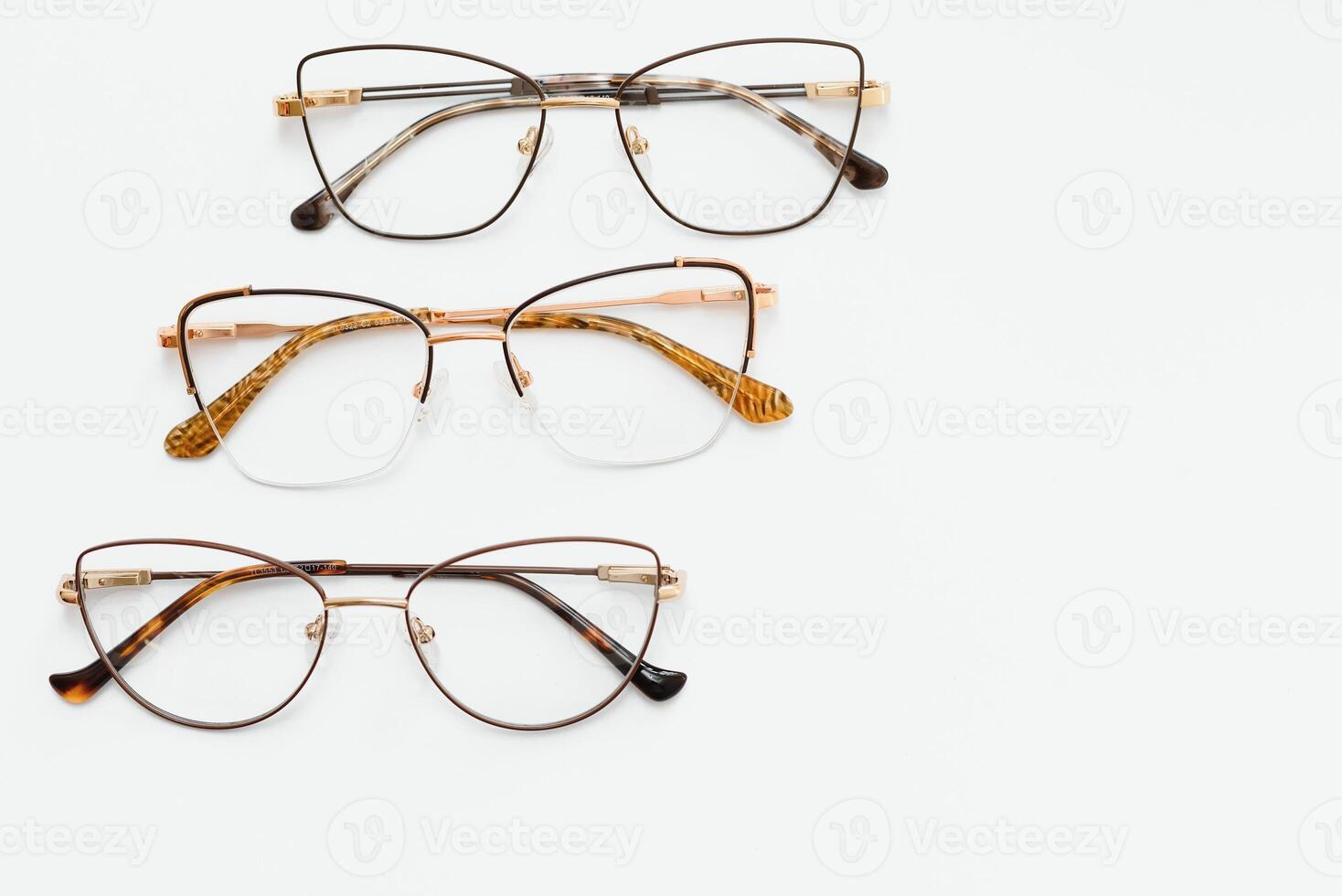Stylish eyeglasses over background. Optical store, glasses selection, eye test, vision examination at optician, fashion accessories concept. Top view, flat lay photo