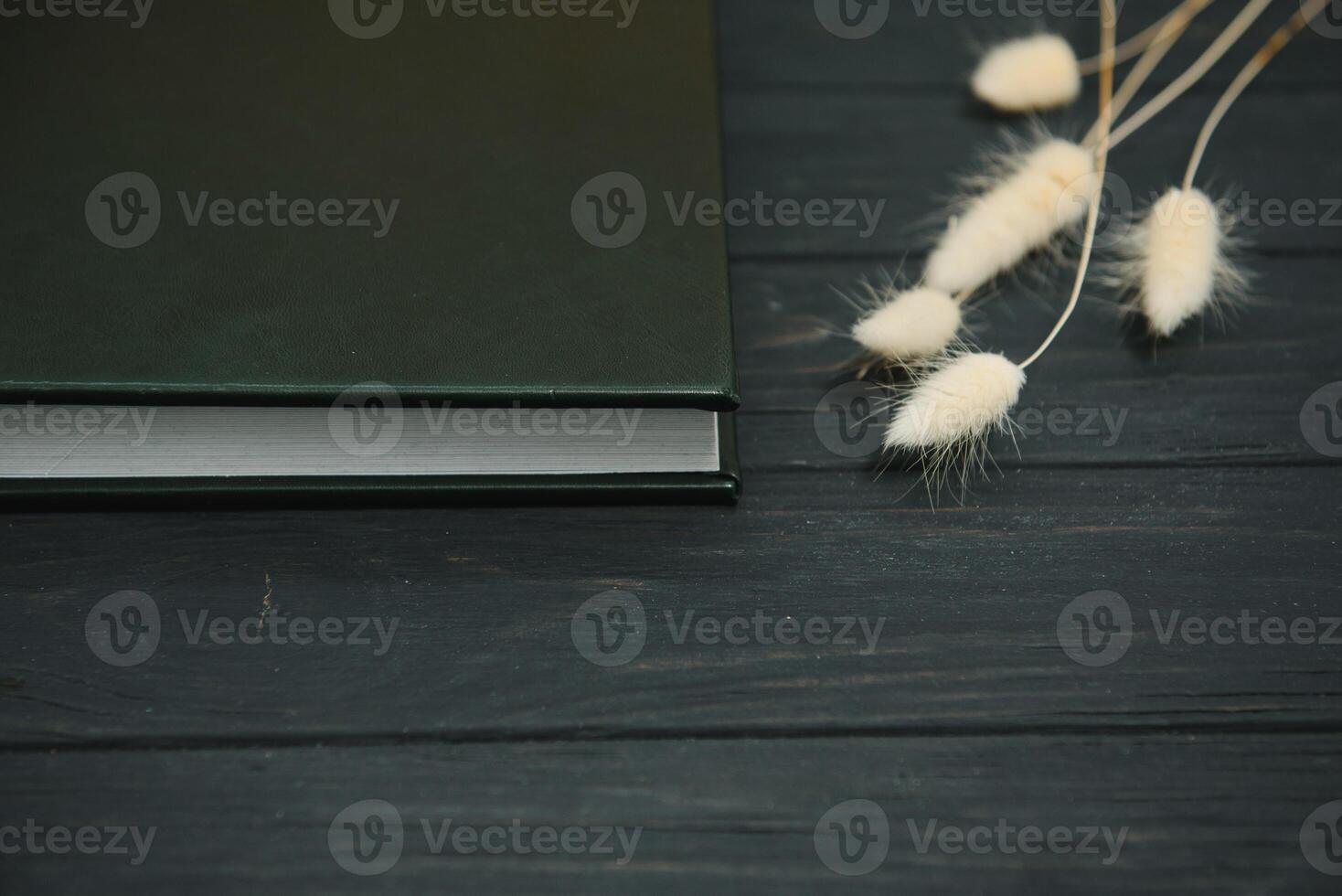 Green wedding or family photo book with leather cover. stylish wedding photo album close up. family photoalbum on wooden background.
