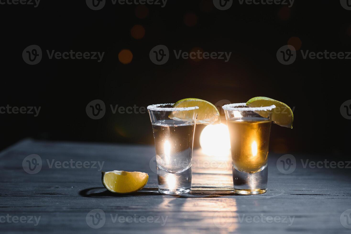 Mexican Tequila with lime and salt on wooden table, selective focus. Copyspace. photo