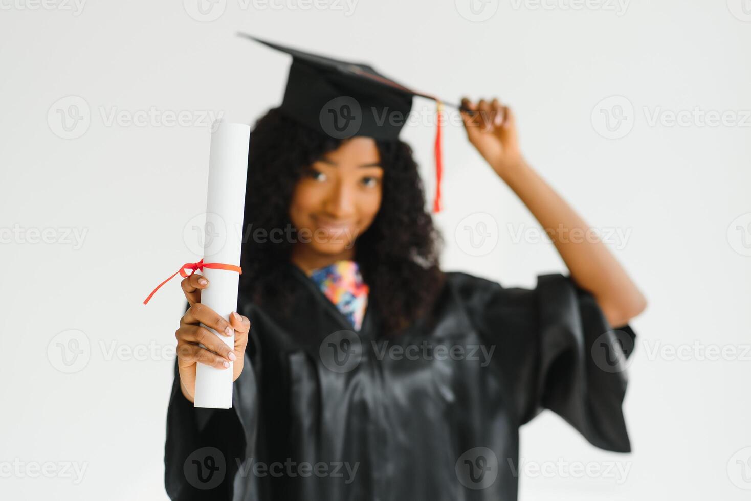 cheerful african american graduate student with diploma in her hand photo