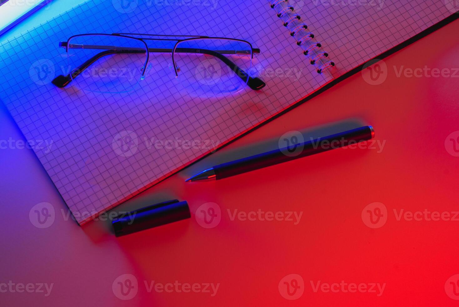 Blank notebook with pen are on top of white office desk table. Top view with copy space, flat lay. photo