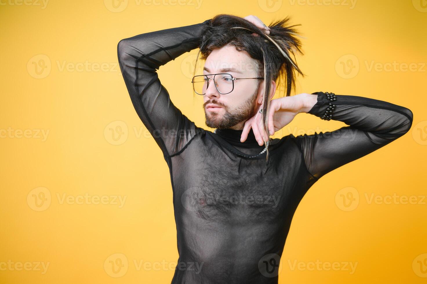 Gay man on a colored background in the studio. The concept of the LGBTQ community. Equality. photo