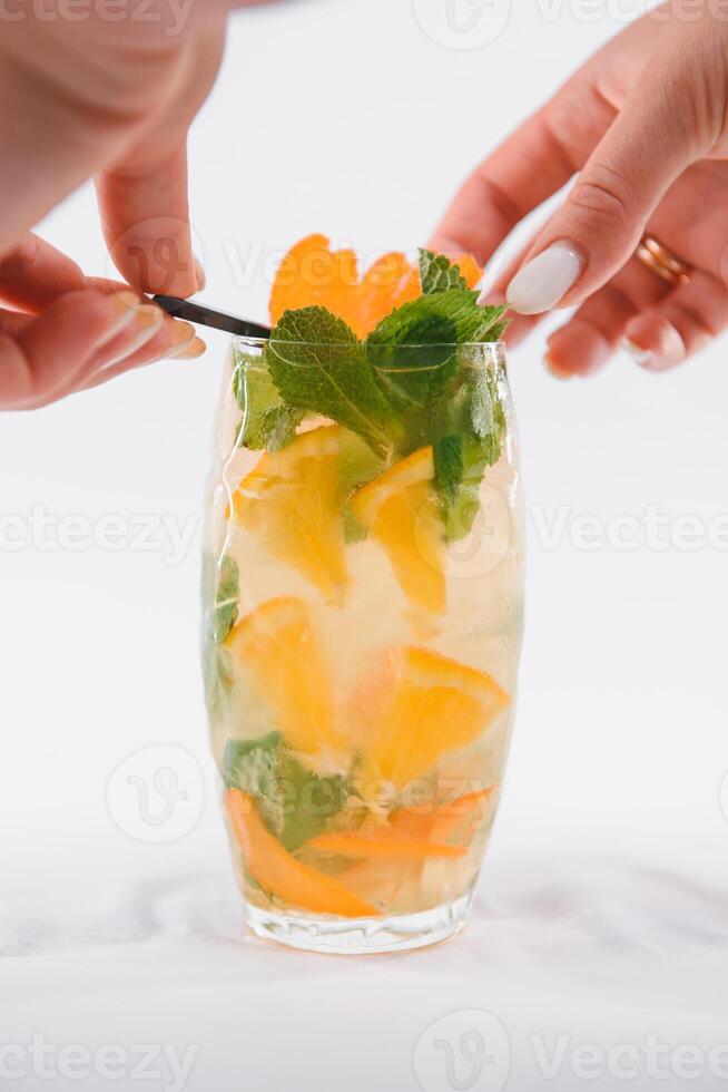 Glasse Of Drink With Ice Cubes And Fruits On White Background photo