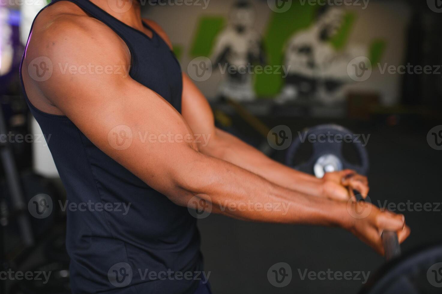 Motivated young black sportsman having workout on rowing machine photo