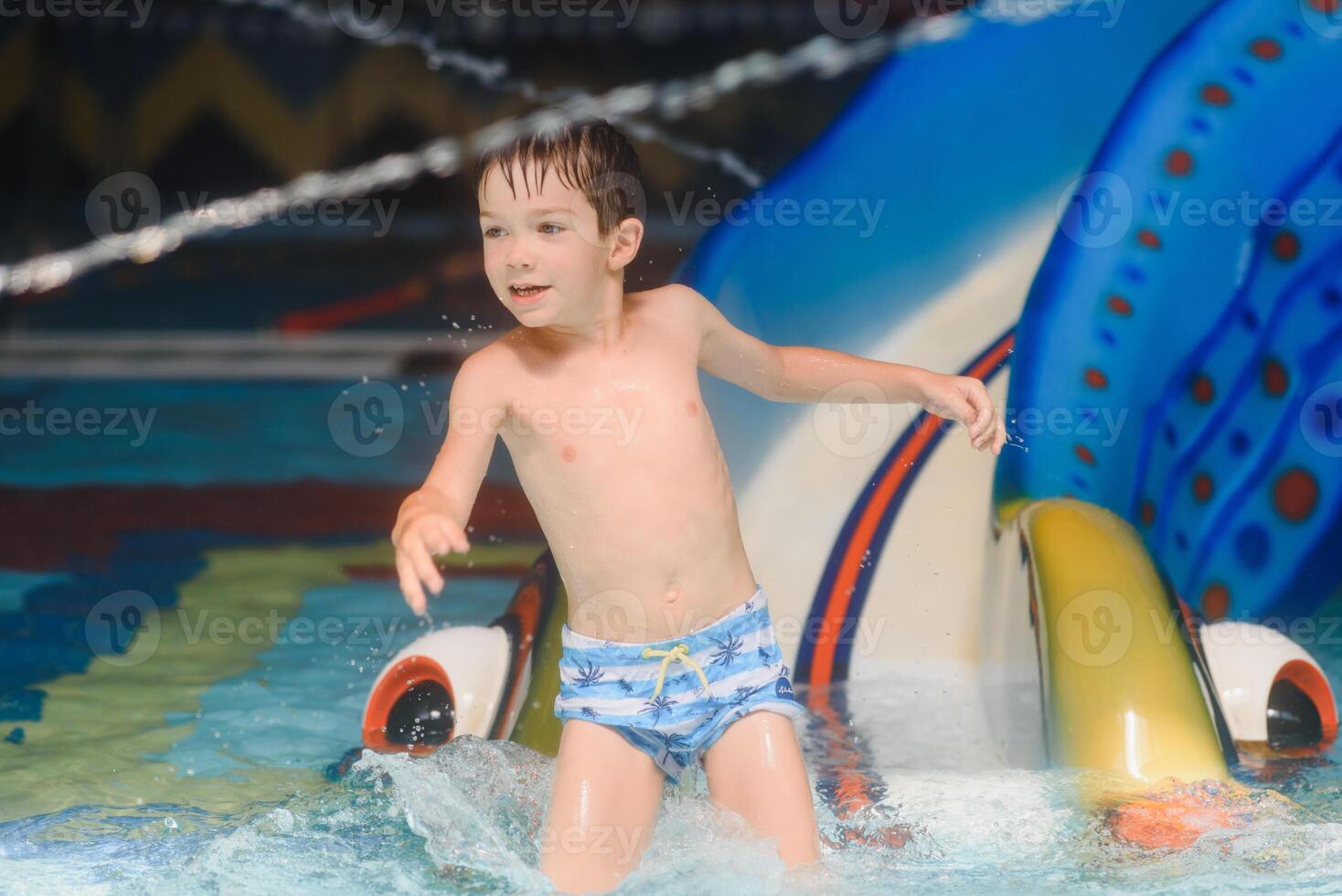 The boy is rolling with a water slide at a water park in Little Rock photo