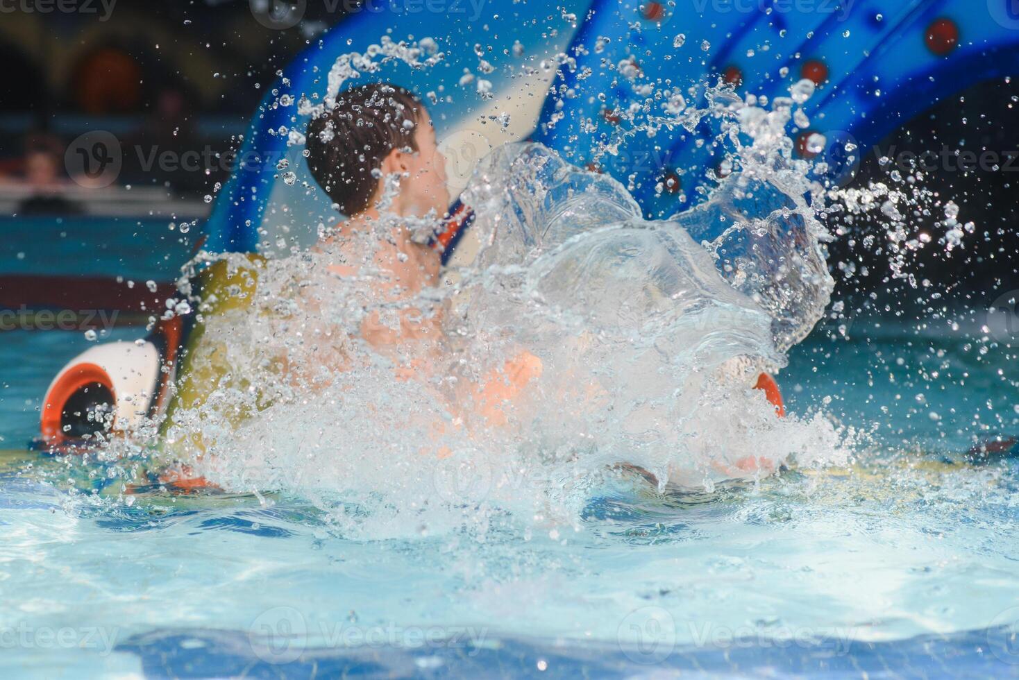 The boy is rolling with a water slide at a water park in Little Rock photo