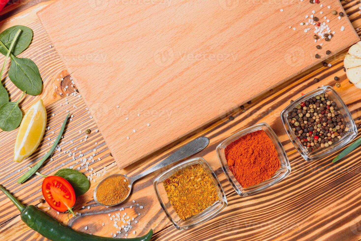 Composition with wooden board and ingredients for cooking on table photo