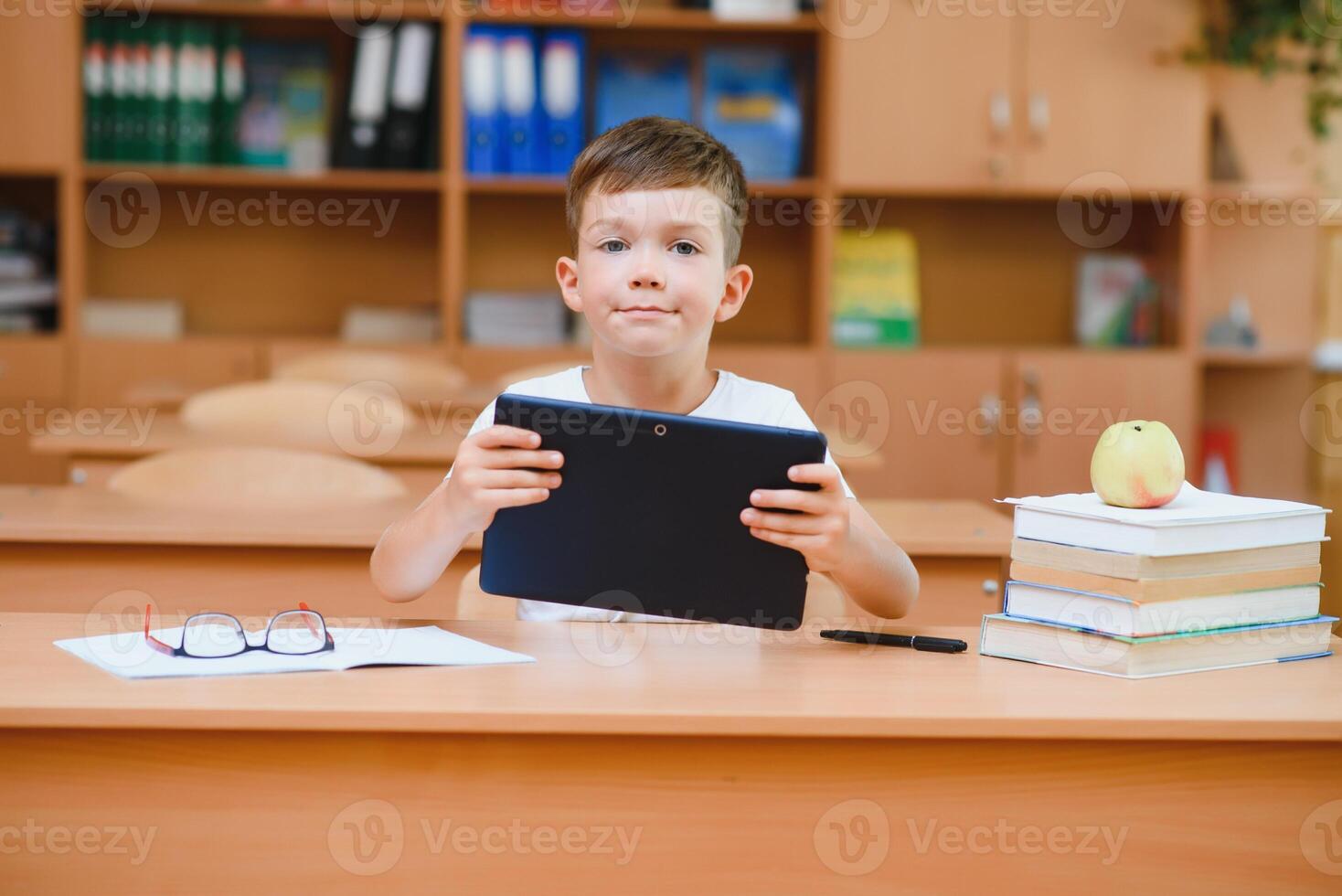 school boy using tablet compute in classroom photo