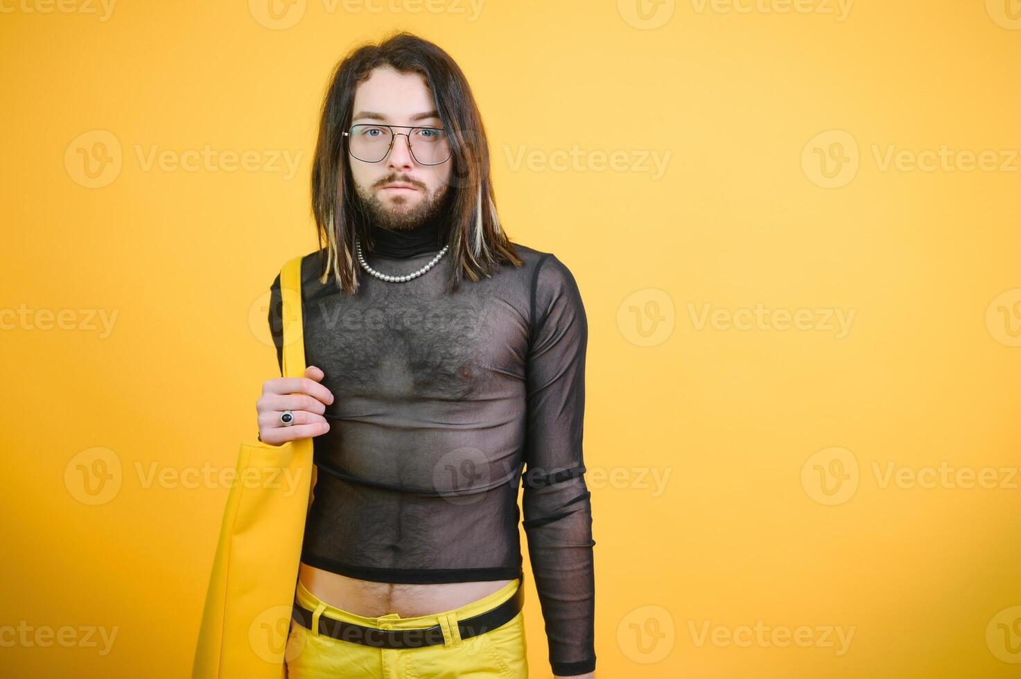 Gay man hold rainbow striped flag isolated on colored background studio portrait. People lifestyle fashion lgbtq concept photo