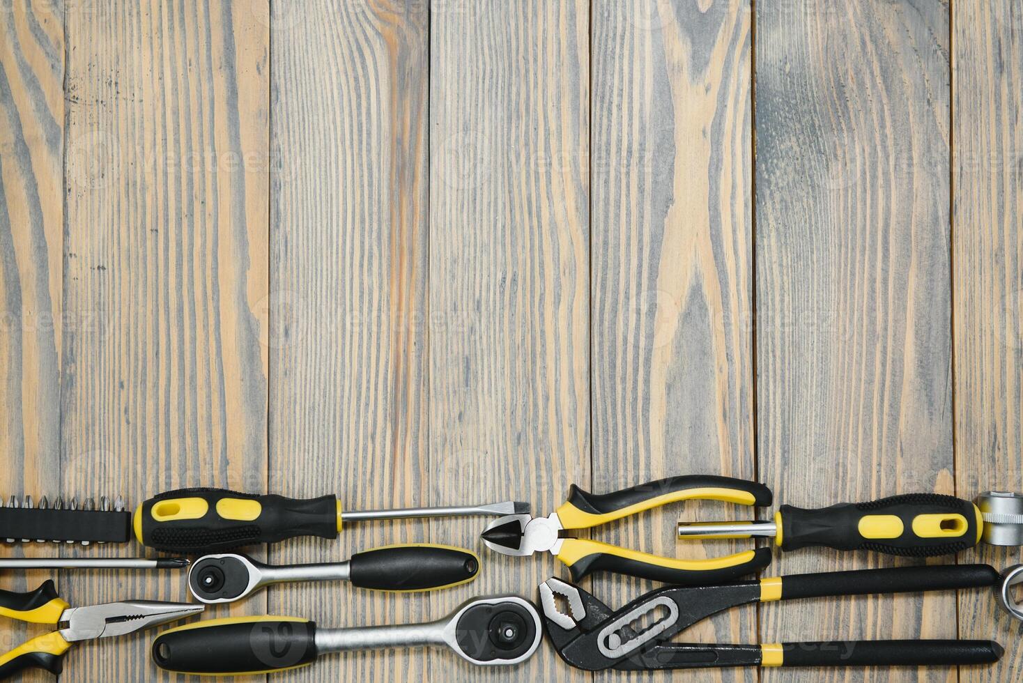 Set of tools over a wood panel with space for text photo
