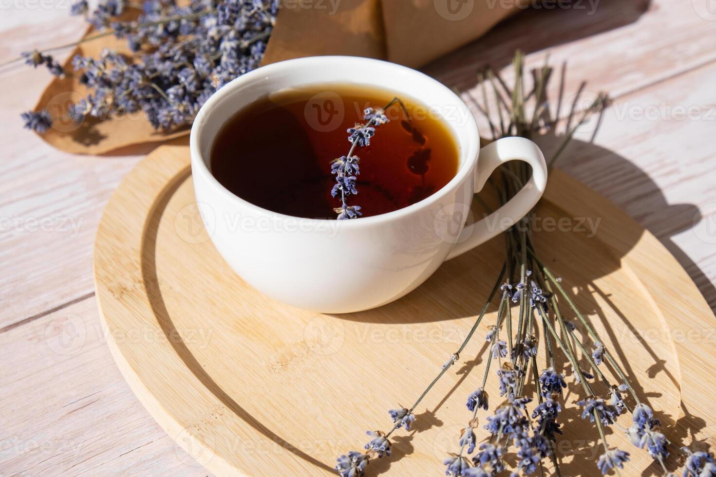 White cup of lavender tea. Mortars of dry lavender alternative medicine. Immunity boosting healthy herbal tea. Lavender flowers. photo