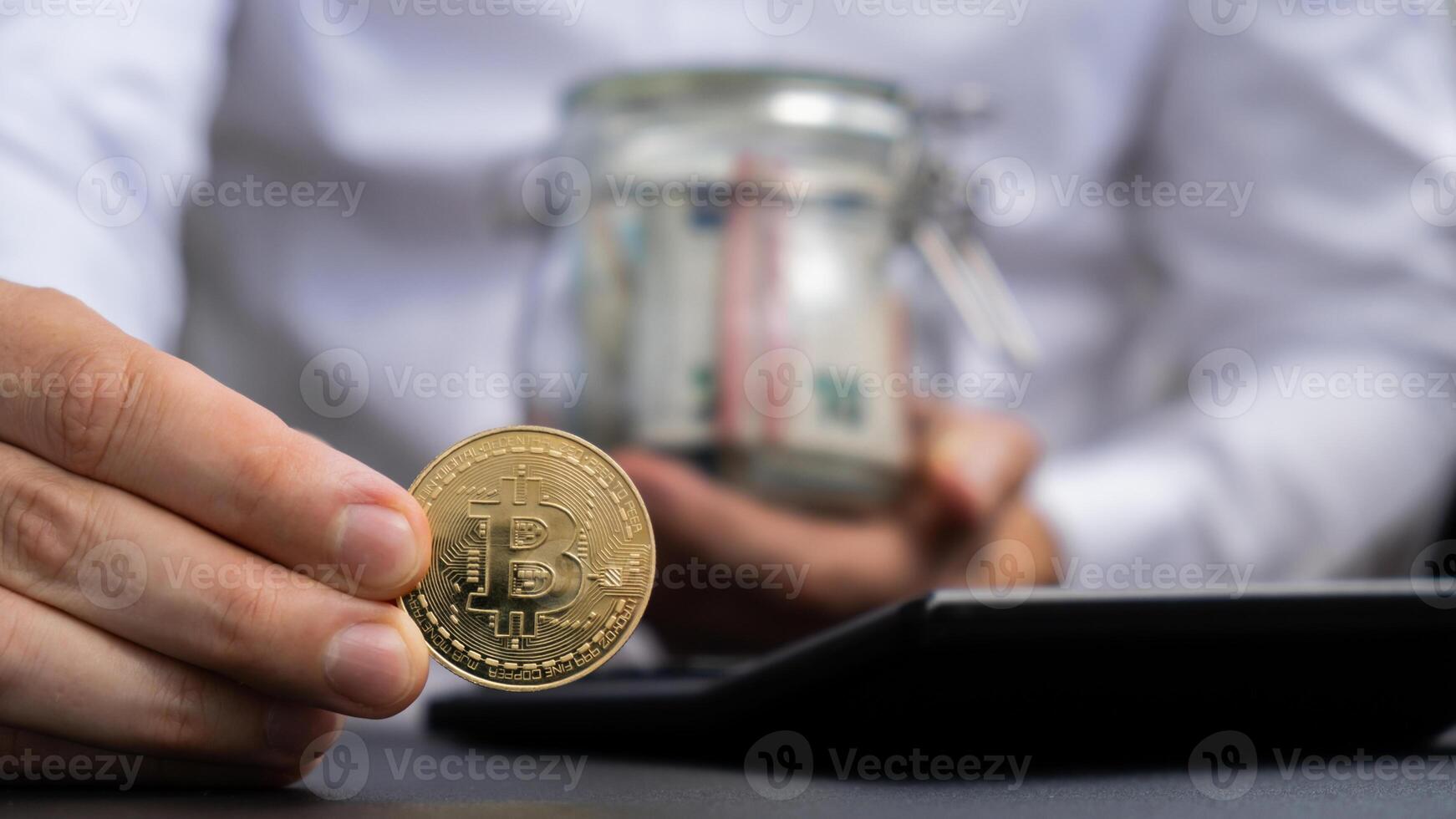 Expert trader hands showing Bitcoin coin digital gold after counting income banknotes of euro cash on calculator. Close up of hands unrecognizable Freelancer. Earned trading charts growth Cryptocurrency market investment concept. Euro fund savings footage photo