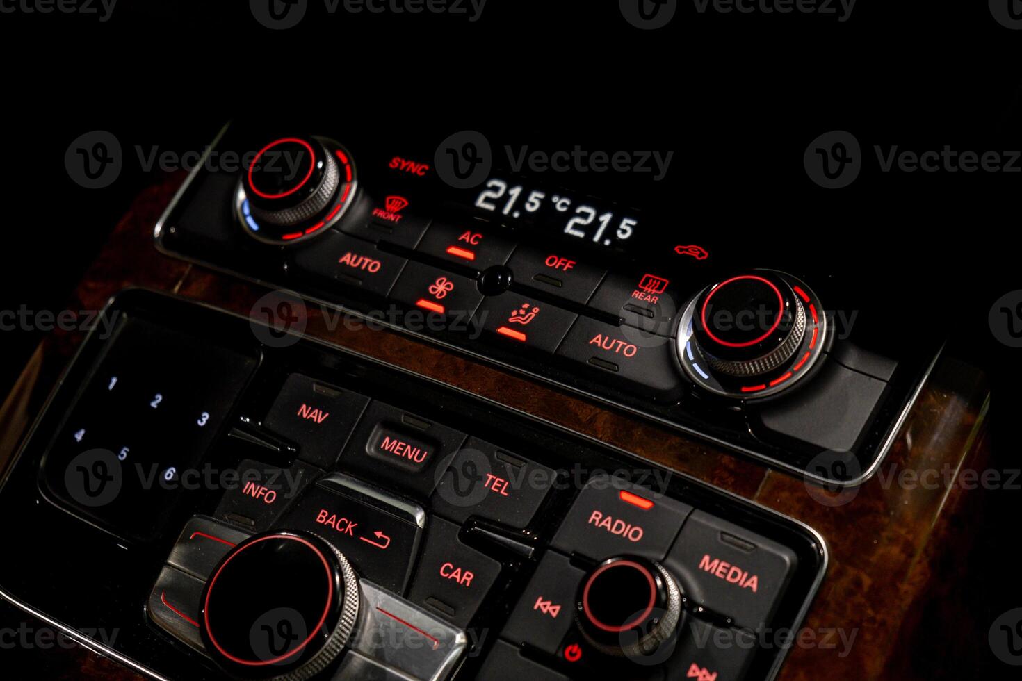 Interior of modern luxury car. Details of automatic transmission gear shift, multimedia control system, car control panel, Air Vent Red emergency button and dashboard inside. Prestige sport automobile. Selective focus photo