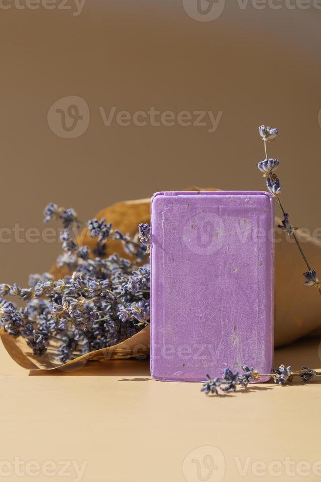 Lavender soap on beige background with copy space for your text. Advertisement template mock up. Skincare homemade natural cosmetic concept. Organic dry lavender flower. Handmade soap photo