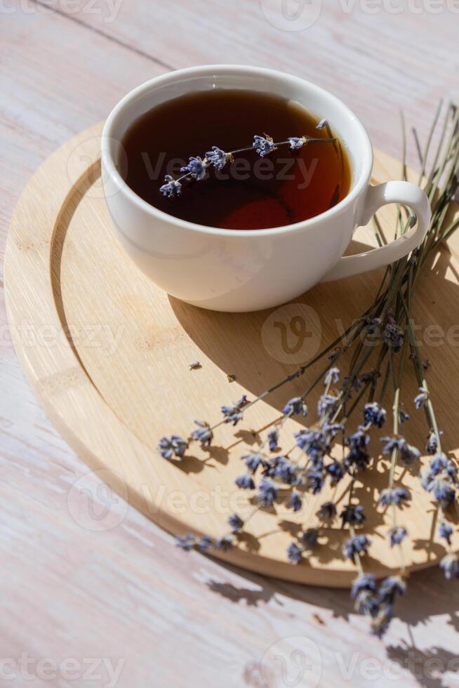 Lavender flowers with herbal cup of tea. Concept of Herbal medicine natural remedy. Organic relieving stress. Healthy beverage fresh delicious floral hot tea. Antispasmodic effect naturopathy concept photo