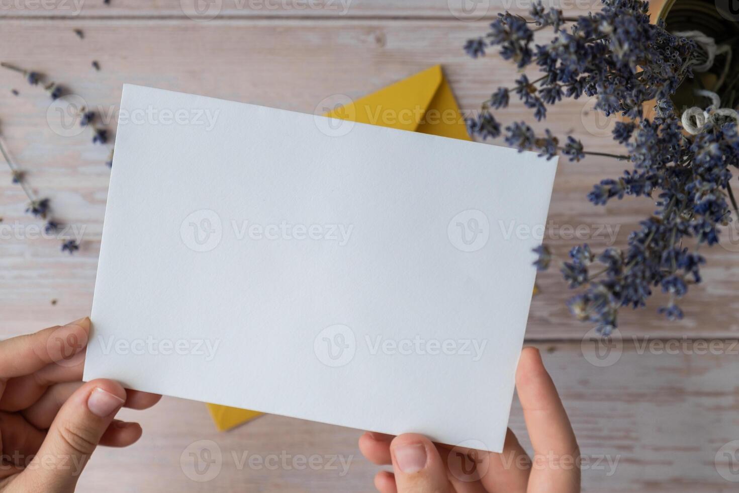 Empty white envelope paper card note template mock up. Copy space for your text. Lavender flower. Greeting or invitation card blank with envelope. Top view, flat lay photo